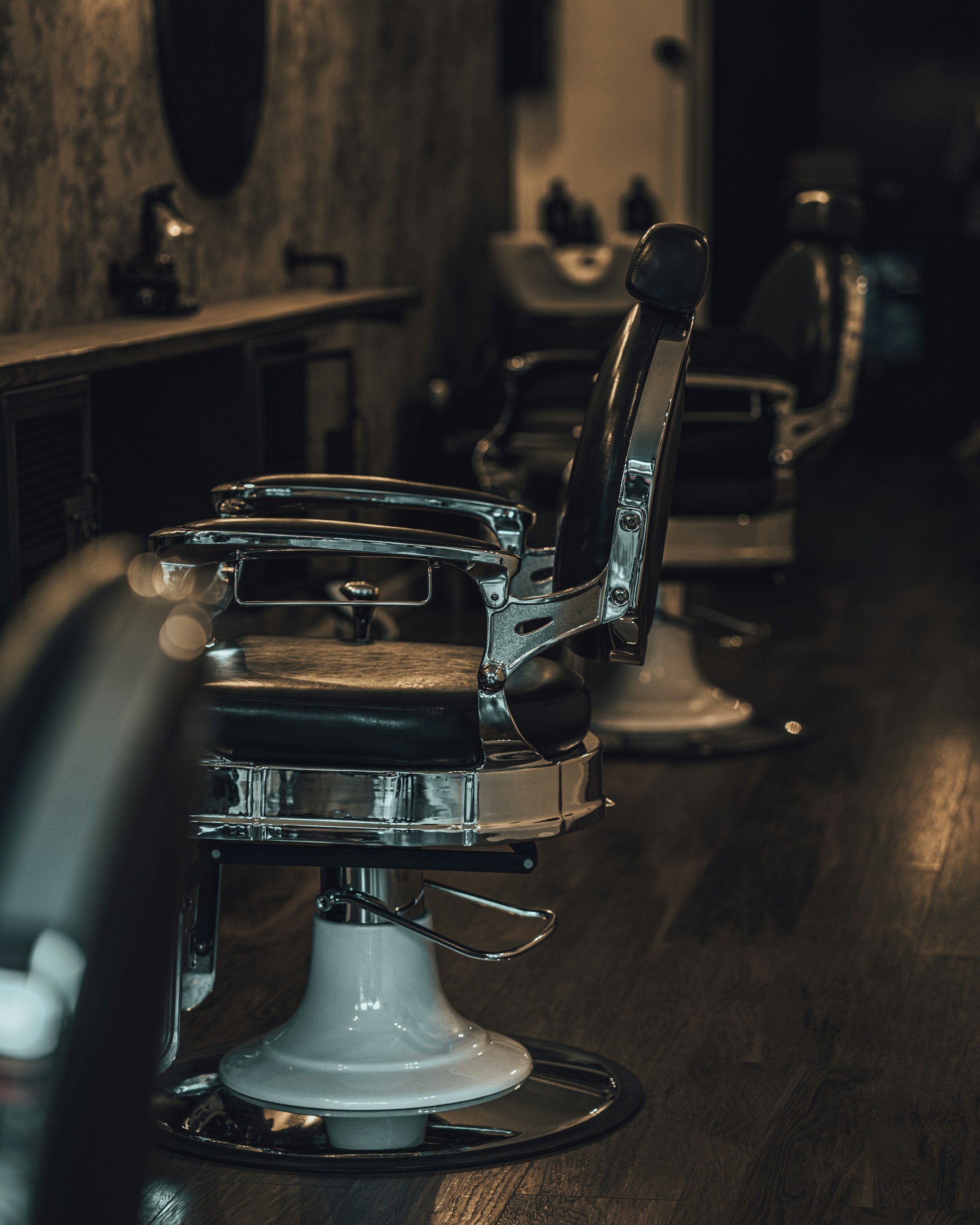 Black and silver barber chair at a styling station, representative of the chairs at Classic Chair Barbershop in Newmarket